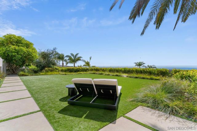 a view of a backyard with plants and patio