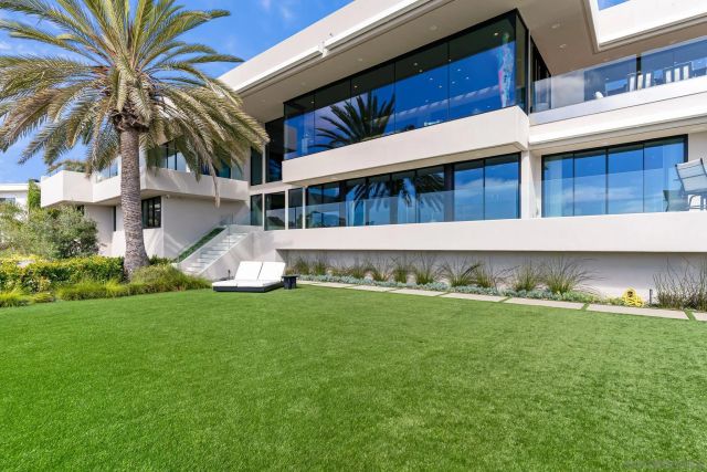 a large bedroom with a large bed and a flat tv screen