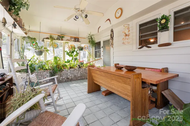 a view of a house with wooden deck and a garden