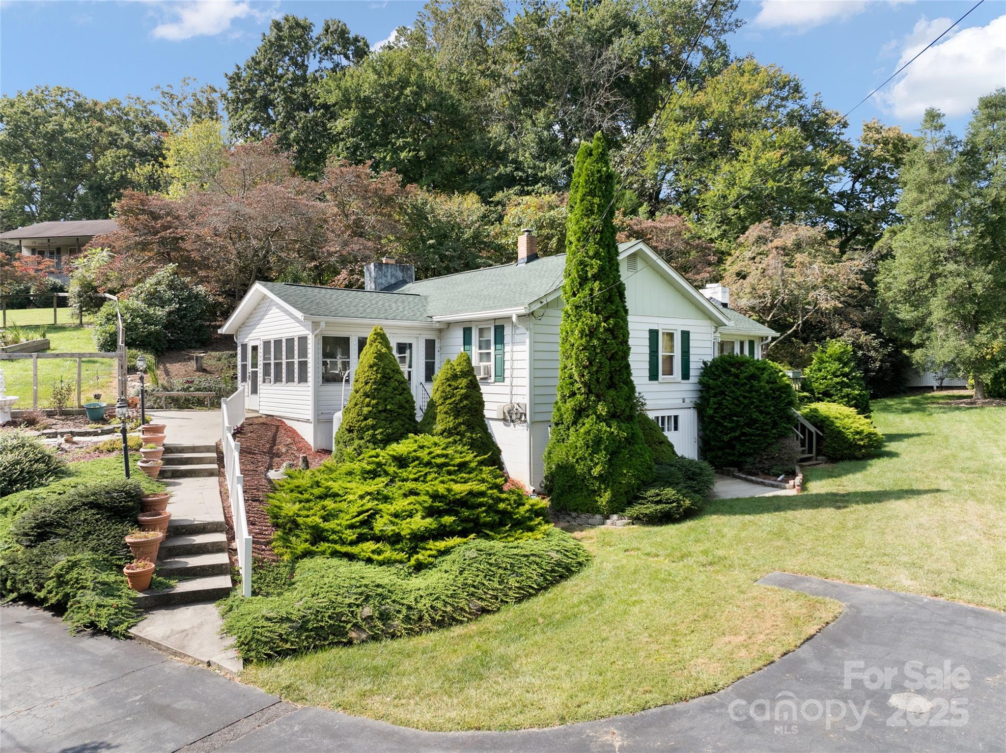 338 Morgan Road Candler, NC 28715 - Photo 3 of 42 a aerial view of a house with swimming pool and garden