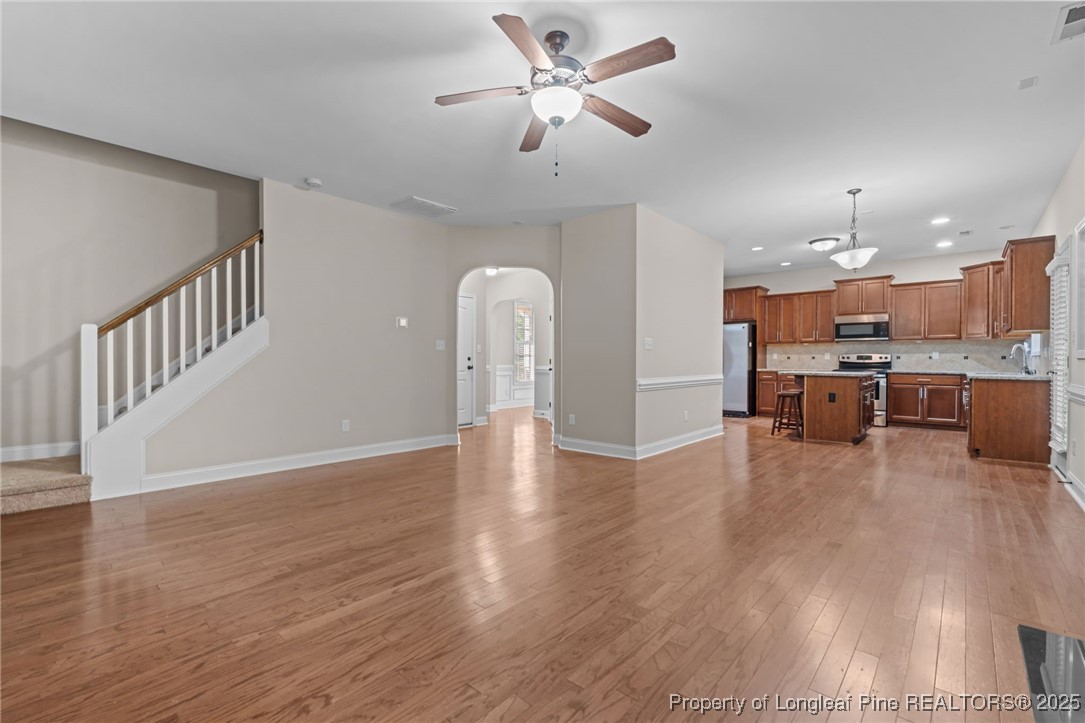 419 Rolling Pines Drive Spring Lake, NC 28390 - Photo 11 of 31 a view of a room with wooden floor and a ceiling fan