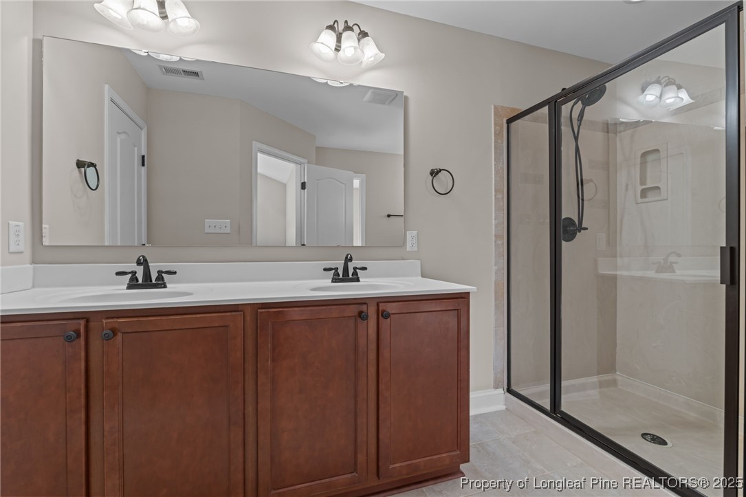 419 Rolling Pines Drive Spring Lake, NC 28390 - Photo 14 of 31 a bathroom with a double vanity sink mirror and shower