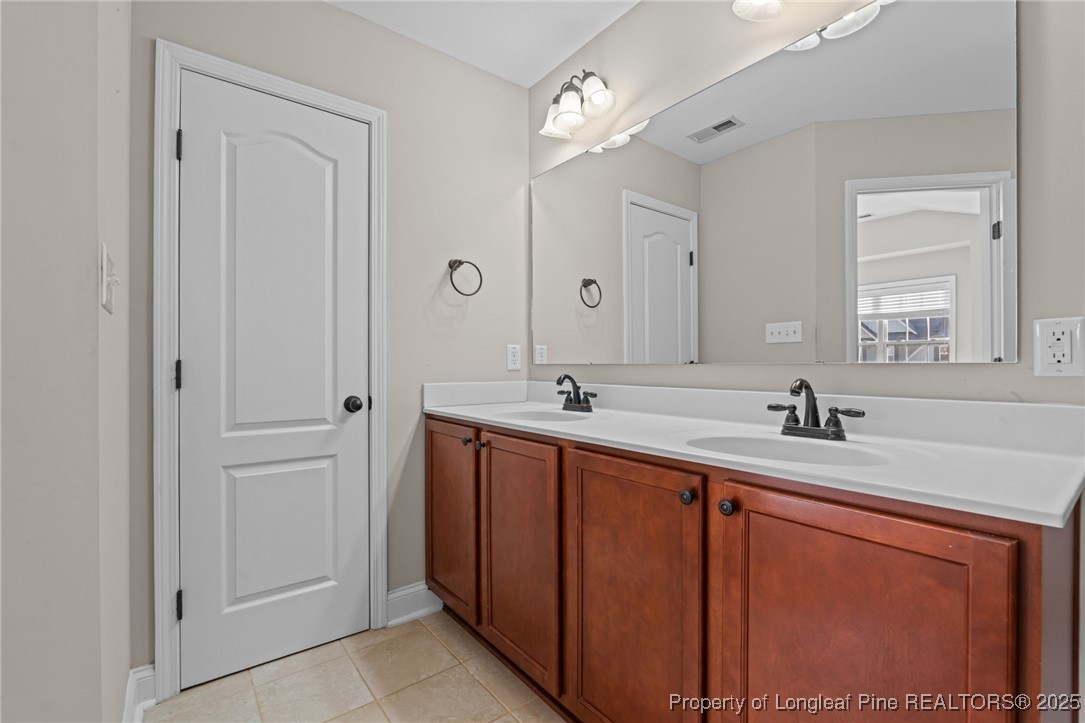 419 Rolling Pines Drive Spring Lake, NC 28390 - Photo 15 of 31 a bathroom with a sink and a mirror