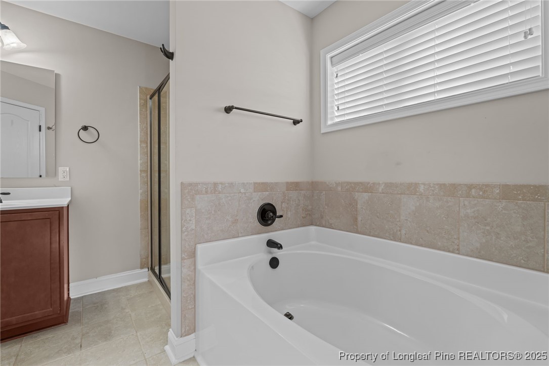419 Rolling Pines Drive Spring Lake, NC 28390 - Photo 16 of 31 a bathroom with a bathtub