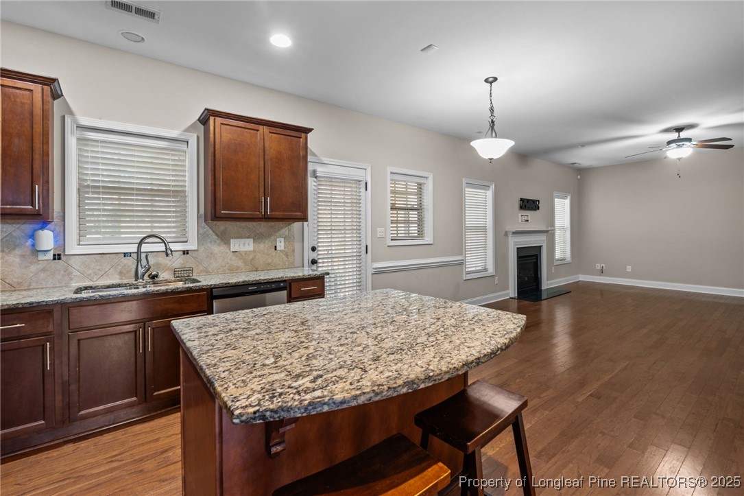 419 Rolling Pines Drive Spring Lake, NC 28390 - Photo 5 of 31 a kitchen with sink cabinets and wooden floor