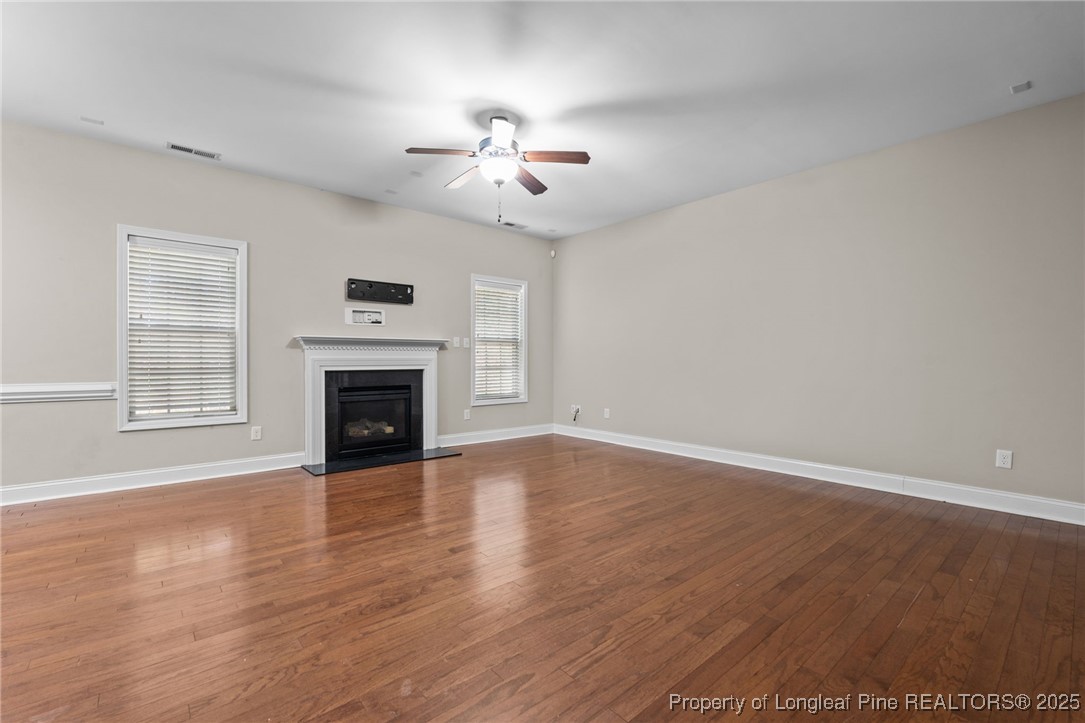 419 Rolling Pines Drive Spring Lake, NC 28390 - Photo 8 of 31 a view of an empty room with wooden floor fireplace and a window