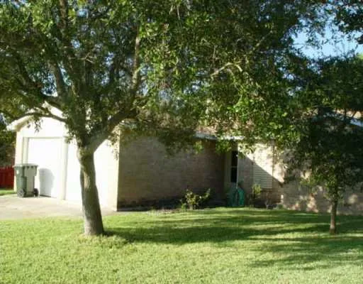 a backyard of a house with lots of green space and fountain