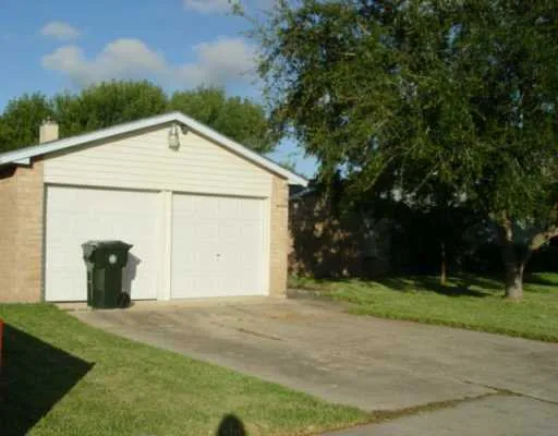 a view of a house with backyard and trees