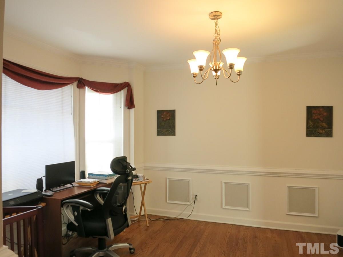 2845 Praire View Point Wendell, NC 27591 - Photo 11 of 25 The Dining Rm, which is currently being used as a Office, offers a hardwood floor, bay window, crown/chair rail molding & brushed nickel light fixture.
