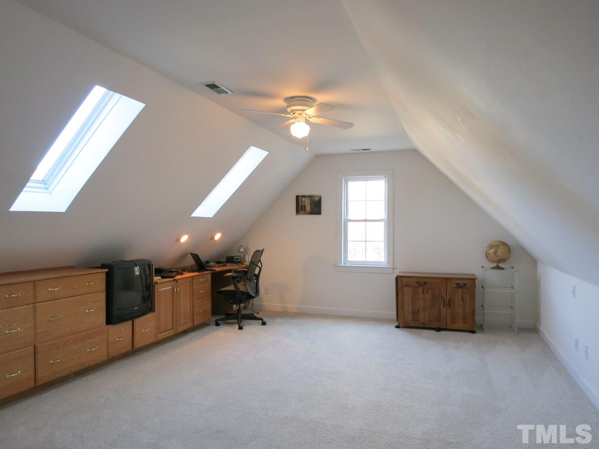 2845 Praire View Point Wendell, NC 27591 - Photo 17 of 25 The lg Bonus Rm could be BR4 w/long built-in Desk/cabinets/drawers, 2 skylights, CF, lg closet & access to under-eaves Attic storage.