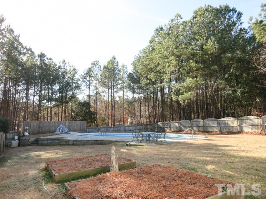 2845 Praire View Point Wendell, NC 27591 - Photo 24 of 25 The huge fenced backyard is surrounded by trees.