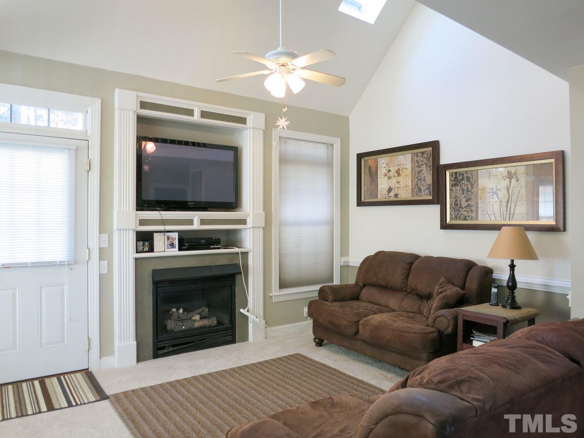 2845 Praire View Point Wendell, NC 27591 - Photo 4 of 25 The spacious vaulted Living Rm offers new neutral carpet, gas log FP w/TV niche above, 2 skylights & glass door to the Deck.
