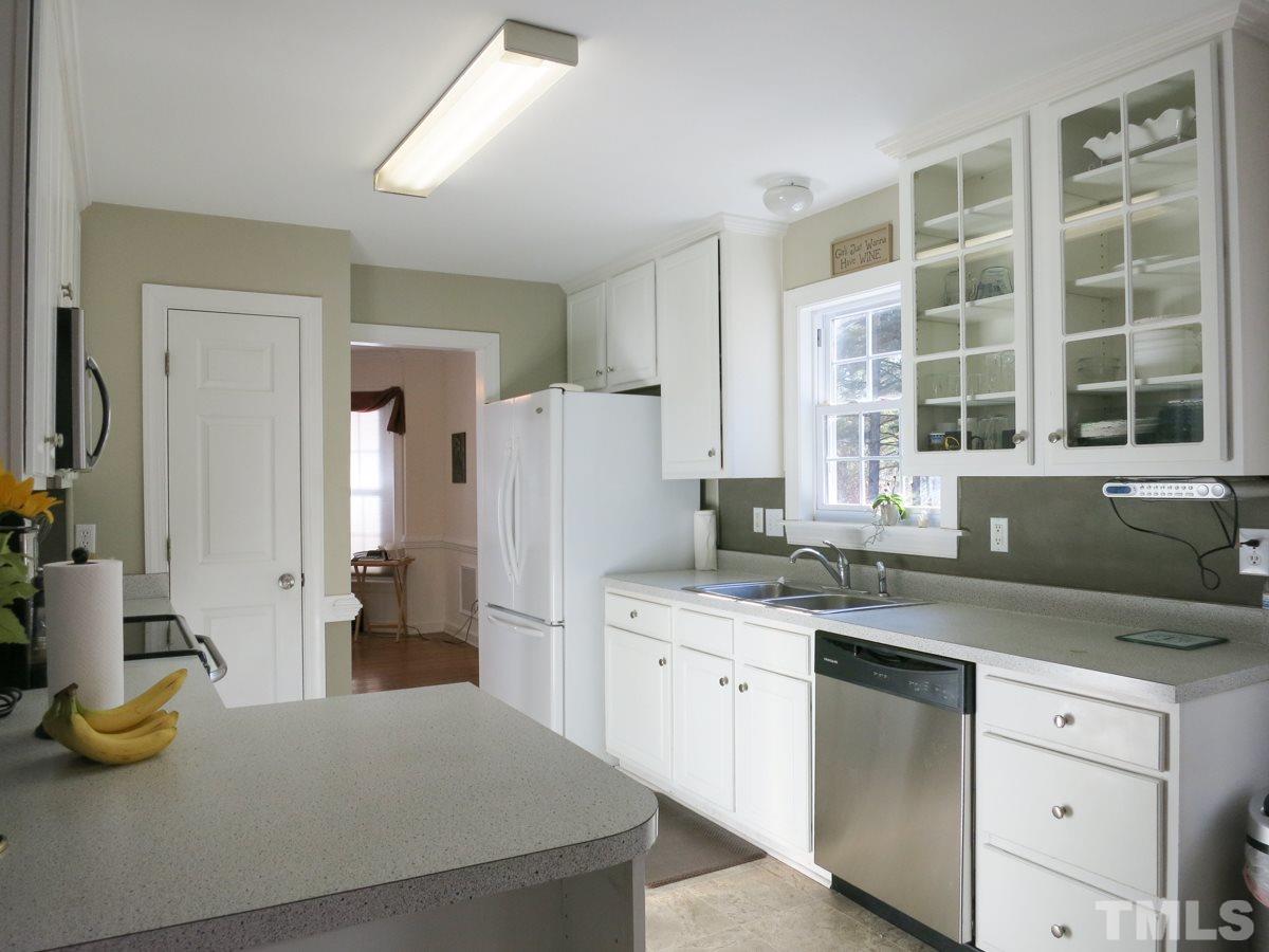 2845 Praire View Point Wendell, NC 27591 - Photo 10 of 25 Another view of the Kitchen. Nearby is the Half Bath and the Laundry/Mud Rm w/vinyl floor, shelving, fold-down ironing board & access to the Garage.