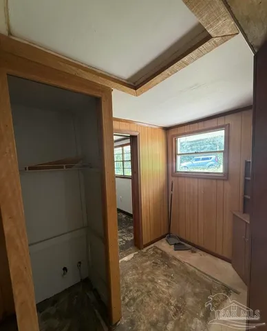 a view of a hallway with wooden shelves