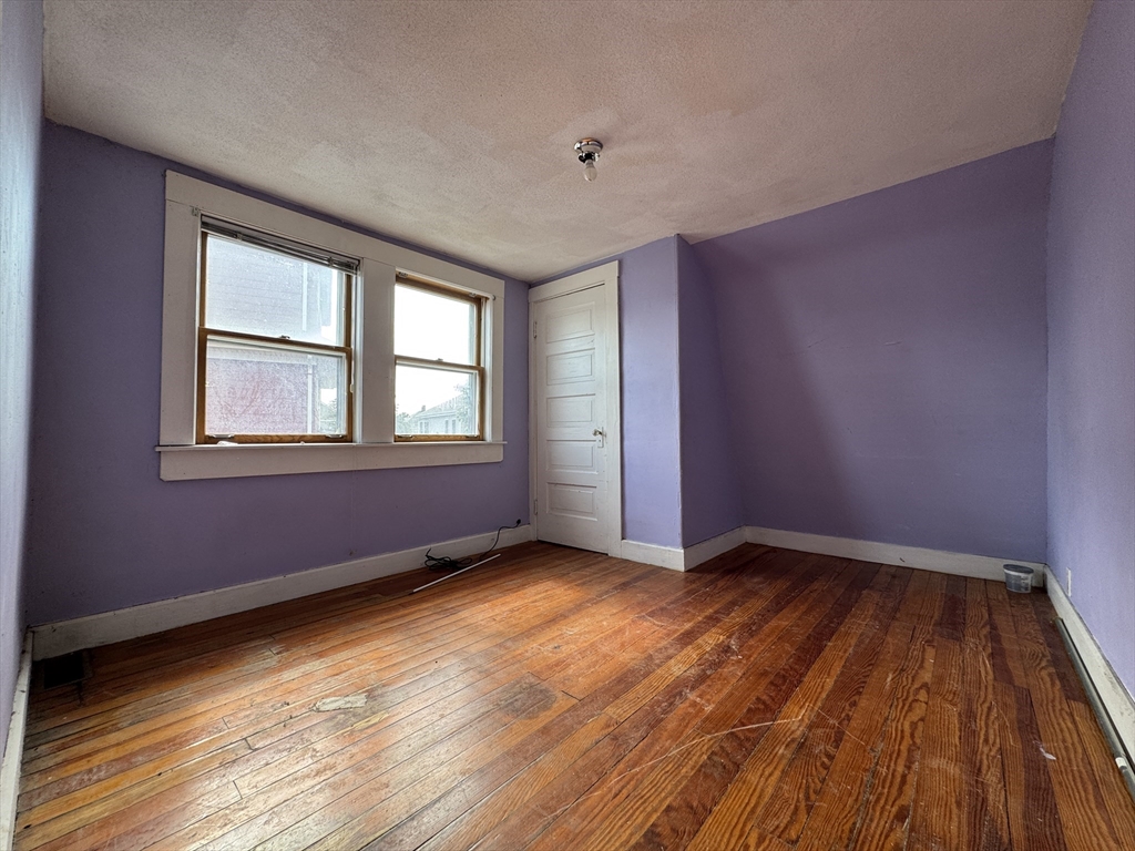 16 Pebble Avenue Winthrop, MA 02152 - Photo 15 of 17 a view of an empty room with wooden floor and a window