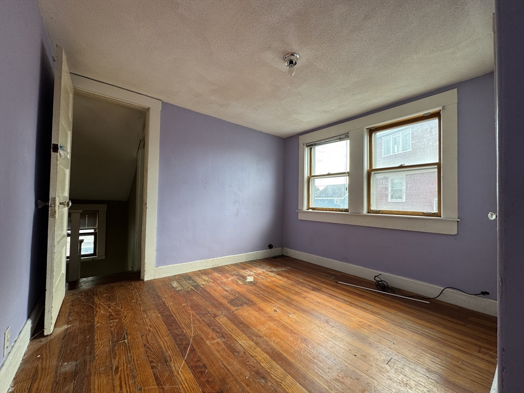 16 Pebble Avenue Winthrop, MA 02152 - Photo 16 of 17 a view of empty room with window and wooden floor