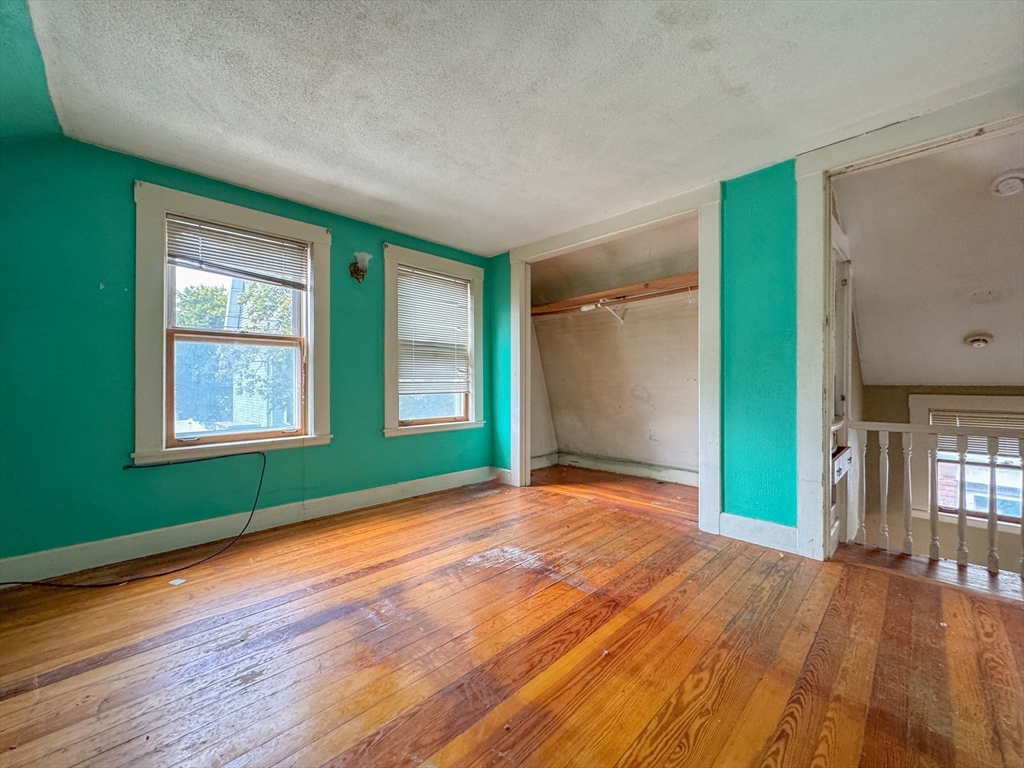16 Pebble Avenue Winthrop, MA 02152 - Photo 5 of 17 a view of an empty room with window and wooden floor