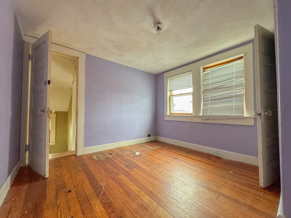 16 Pebble Avenue Winthrop, MA 02152 - Photo 6 of 17 a view of empty room with wooden floor and fan