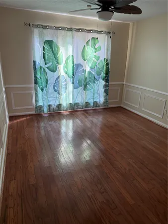 a view of room with window and wooden floor