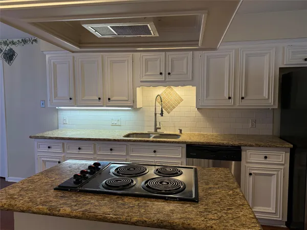 a kitchen with a stove and cabinets