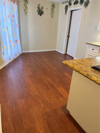 a view of a kitchen from a hallway