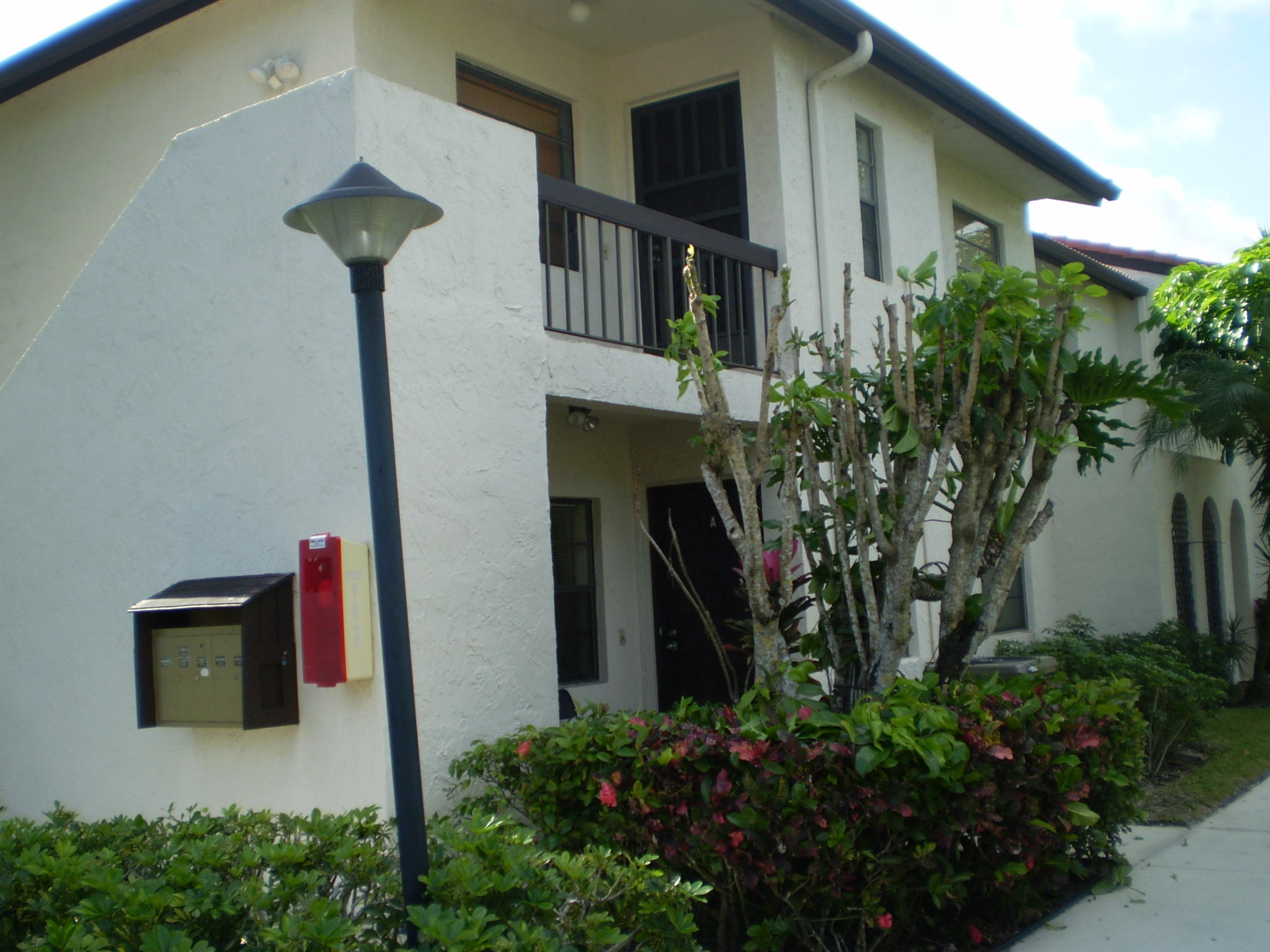 7970 Eastlake Drive, Unit 15A Boca Raton, FL 33433 - Photo 1 of 12 a front view of a house with yard
