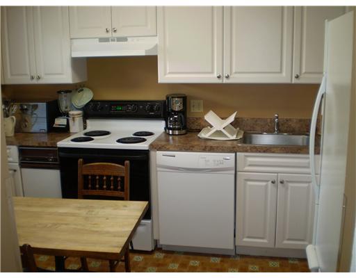 7970 Eastlake Drive, Unit 15A Boca Raton, FL 33433 - Photo 3 of 12 a kitchen with stainless steel appliances granite countertop a stove a sink and a white cabinets