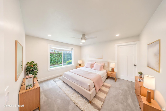 2169 Orchard Pines Loop East Bountiful, UT 84010 - Photo 10 of 32 Spacious room featuring light gray carpeting, a large window, recessed lighting, a ceiling fan, and a three-panel door