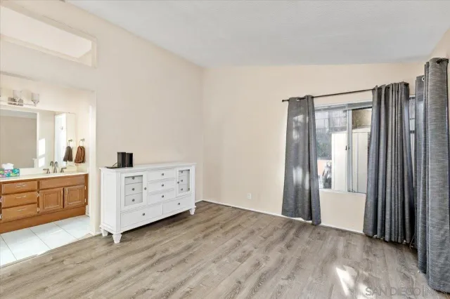 a bedroom with a bed and balcony