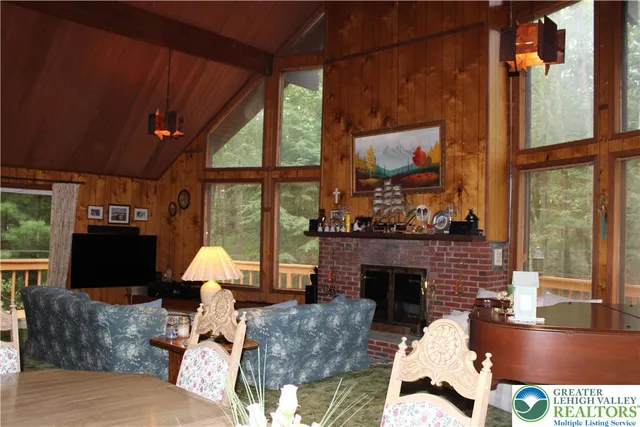 a living room with furniture a window and a fireplace
