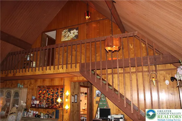 a living room with fireplace furniture and a floor to ceiling window