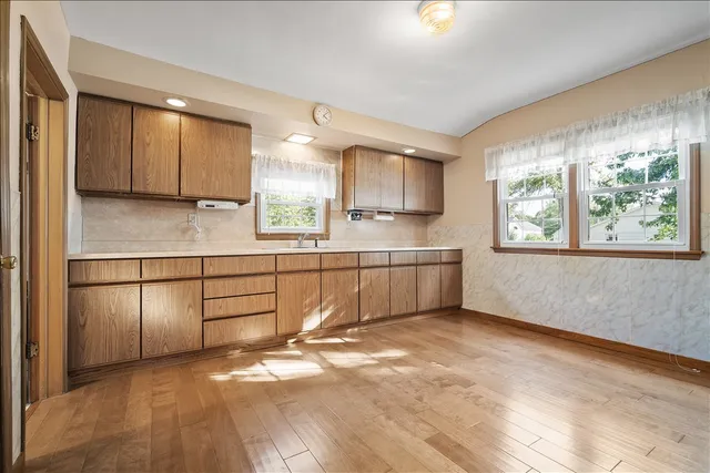 a kitchen with stainless steel appliances a refrigerator sink and cabinets