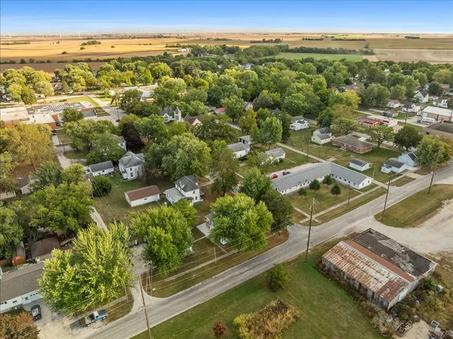 an aerial view of residential houses with outdoor space and ocean view