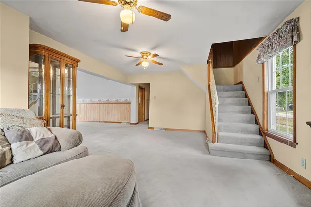 a living room with furniture and a chandelier