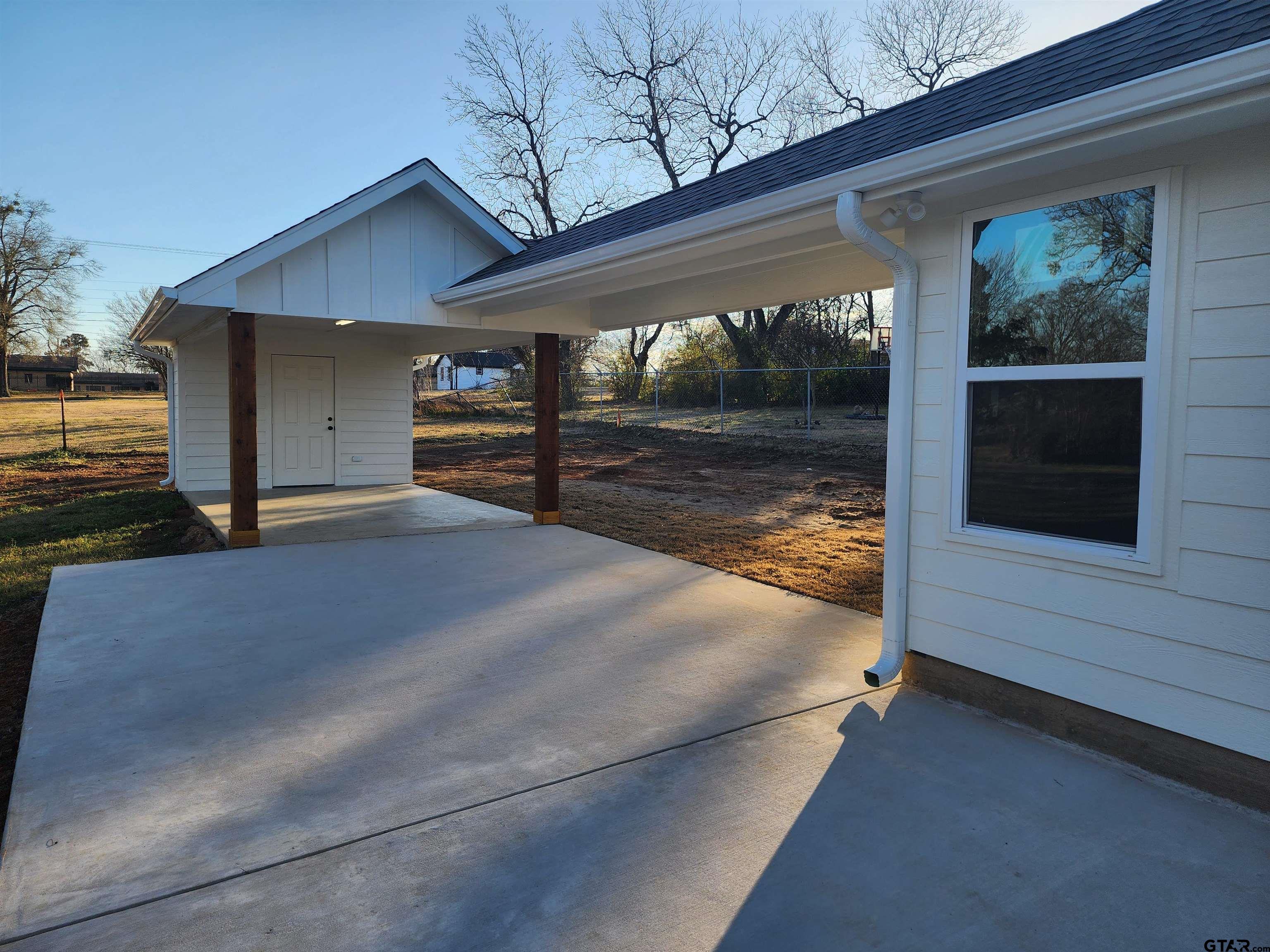 412 Garver Street Pittsburg, TX 75686 - Photo 13 of 14 a view of a house with a yard