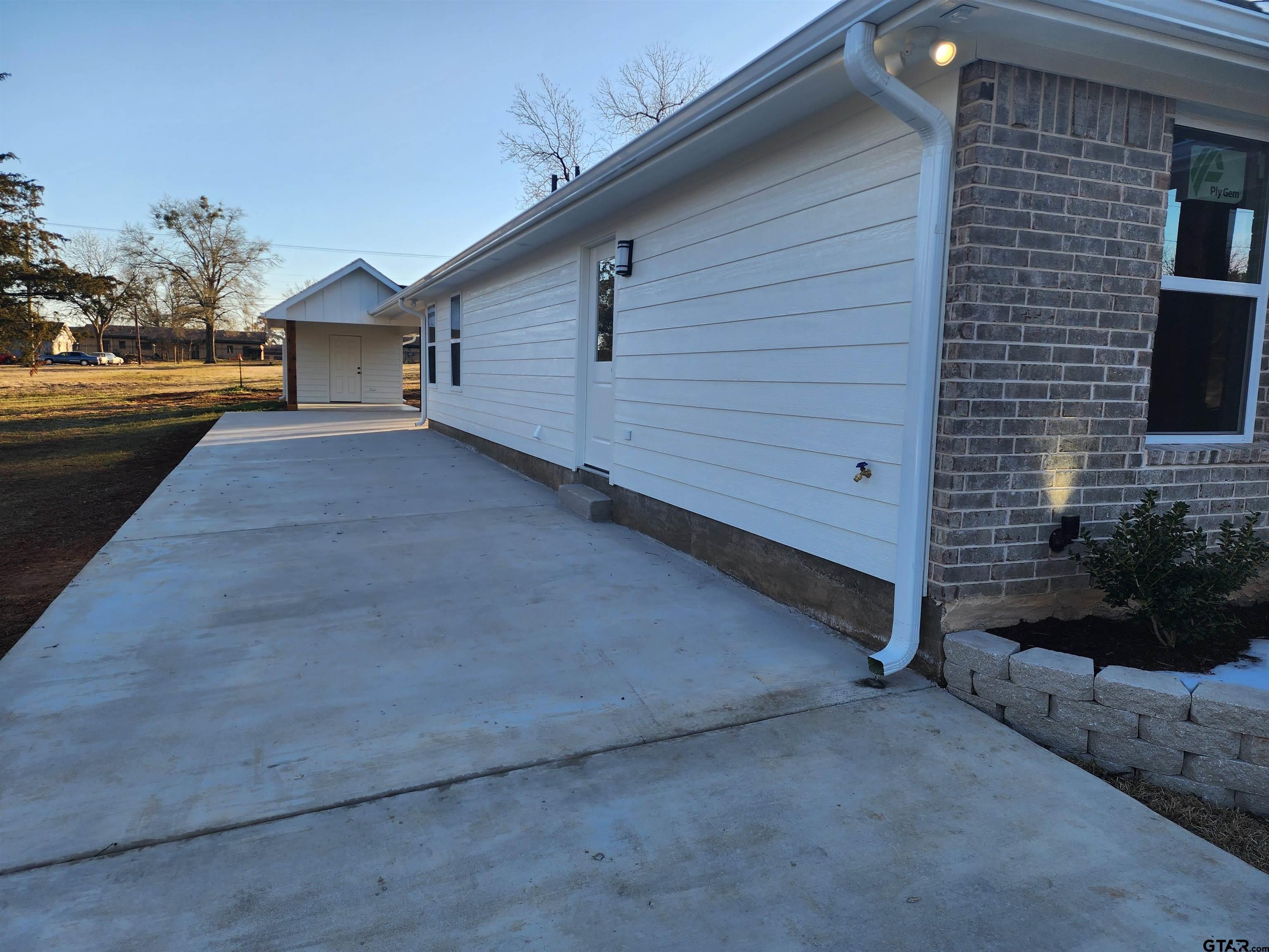 412 Garver Street Pittsburg, TX 75686 - Photo 14 of 14 a view of a house with a yard and garage