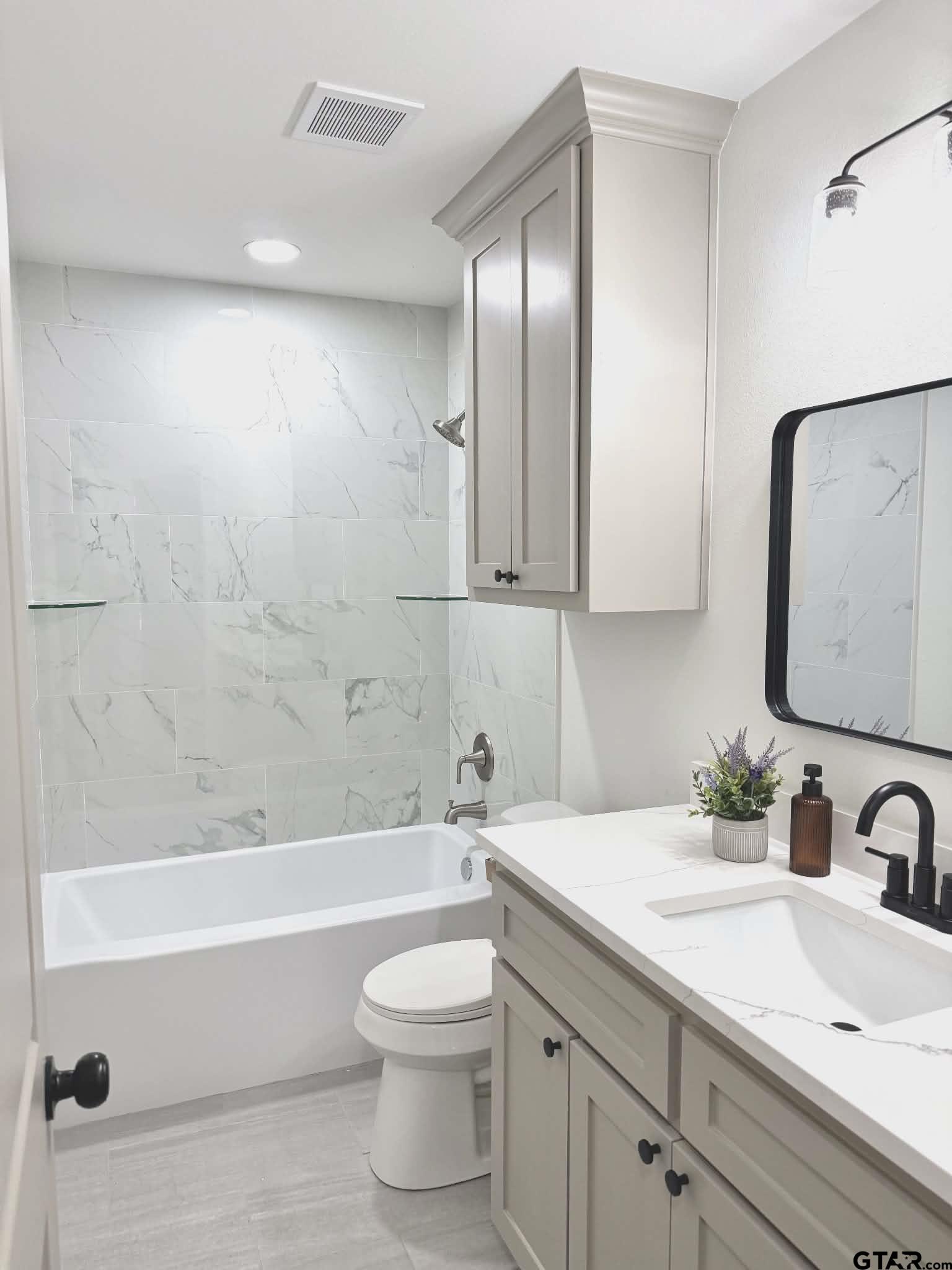 412 Garver Street Pittsburg, TX 75686 - Photo 7 of 11 a bathroom with a sink a toilet and bathtub