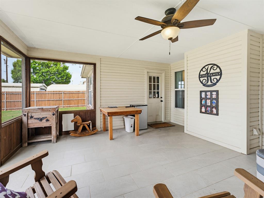 2108 Ridgewood Drive Bridgeport, TX 76426 - Photo 31 of 35 Enclosed patio featuring light-toned tile flooring, white plank siding, a ceiling fan with integrated lighting, and multiple windows