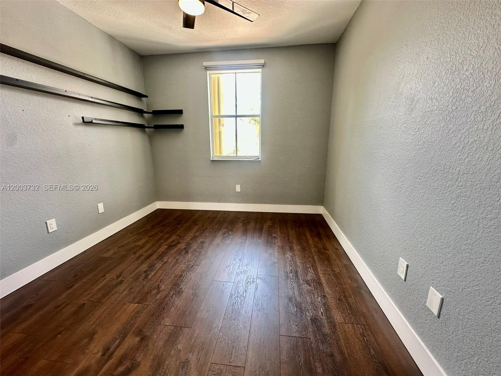 16537 Southwest 78th Terrace Miami, FL 33193 - Photo 13 of 34 a view of a room with wooden floor staircase and a window