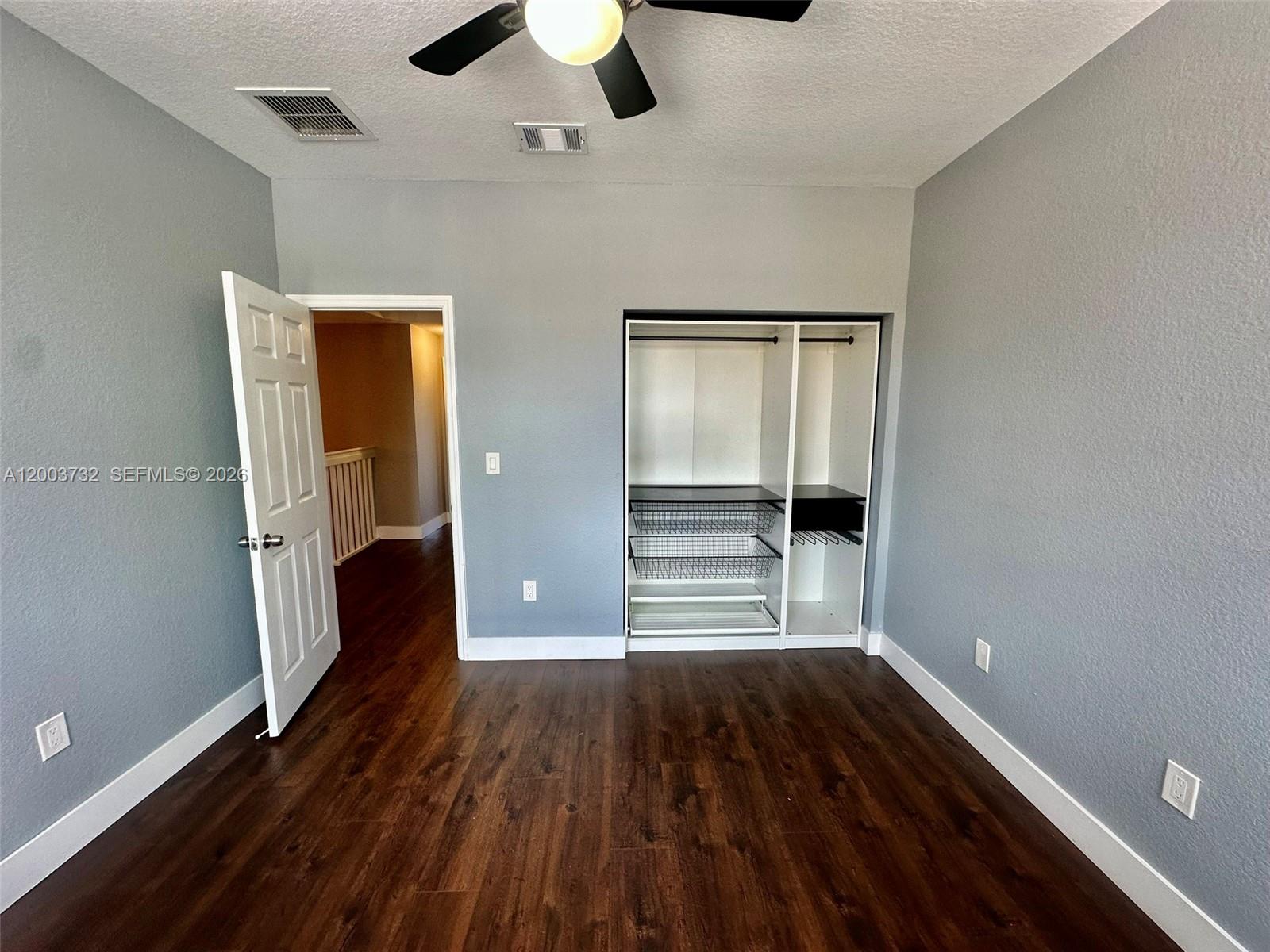 16537 Southwest 78th Terrace Miami, FL 33193 - Photo 15 of 34 wooden floor in an empty room with a window