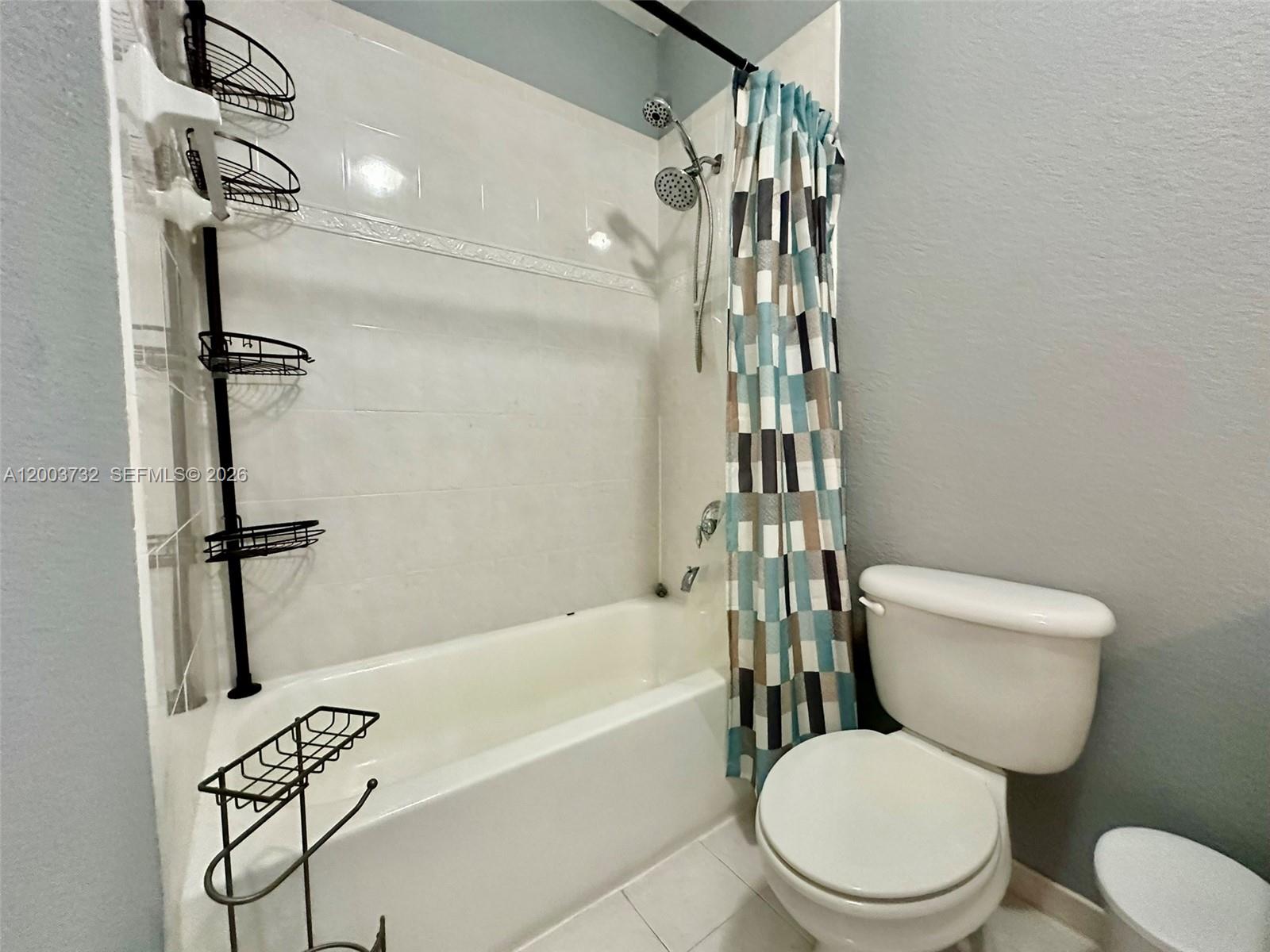 16537 Southwest 78th Terrace Miami, FL 33193 - Photo 16 of 34 a white toilet sitting next to a bath tub