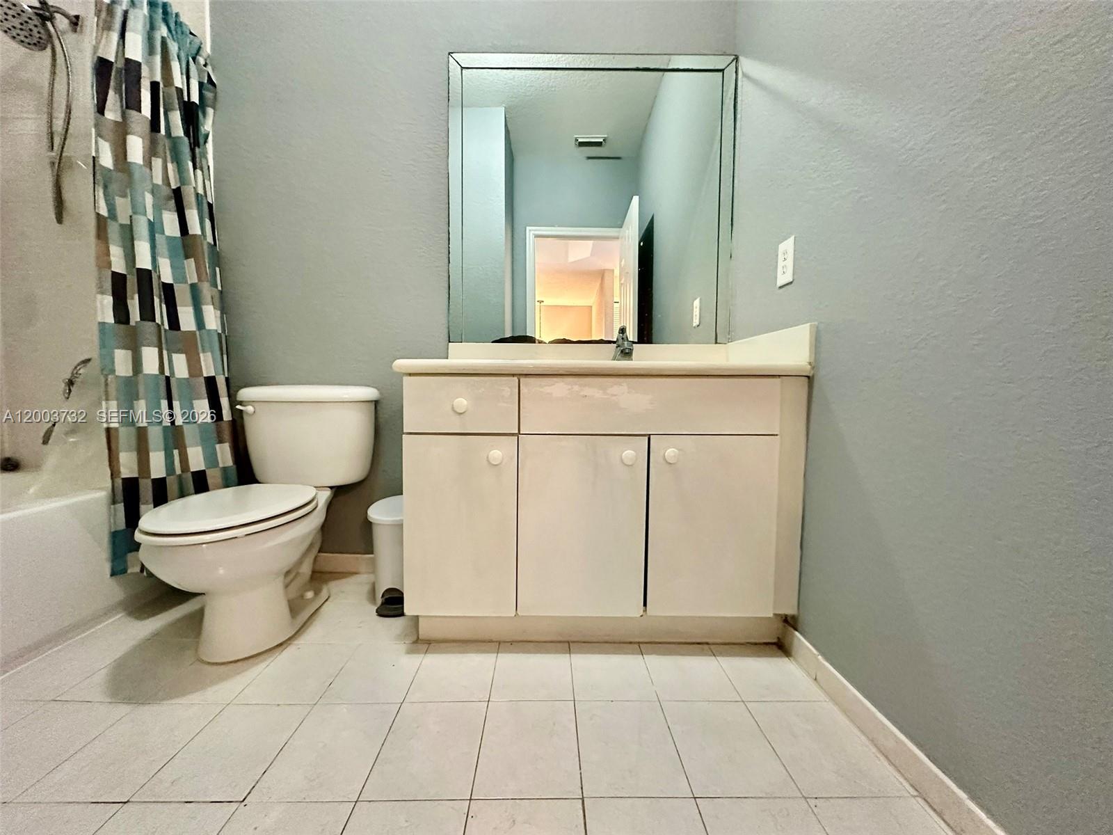16537 Southwest 78th Terrace Miami, FL 33193 - Photo 17 of 34 a bathroom with a toilet sink and mirror