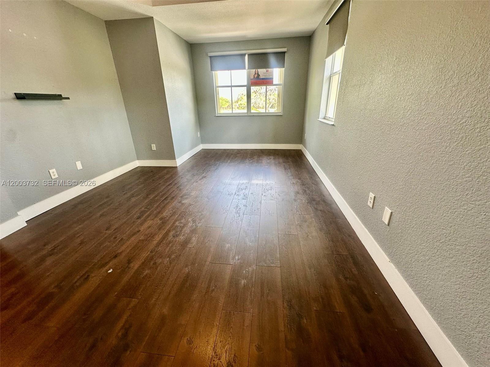 16537 Southwest 78th Terrace Miami, FL 33193 - Photo 19 of 34 wooden floor in an empty room with a window