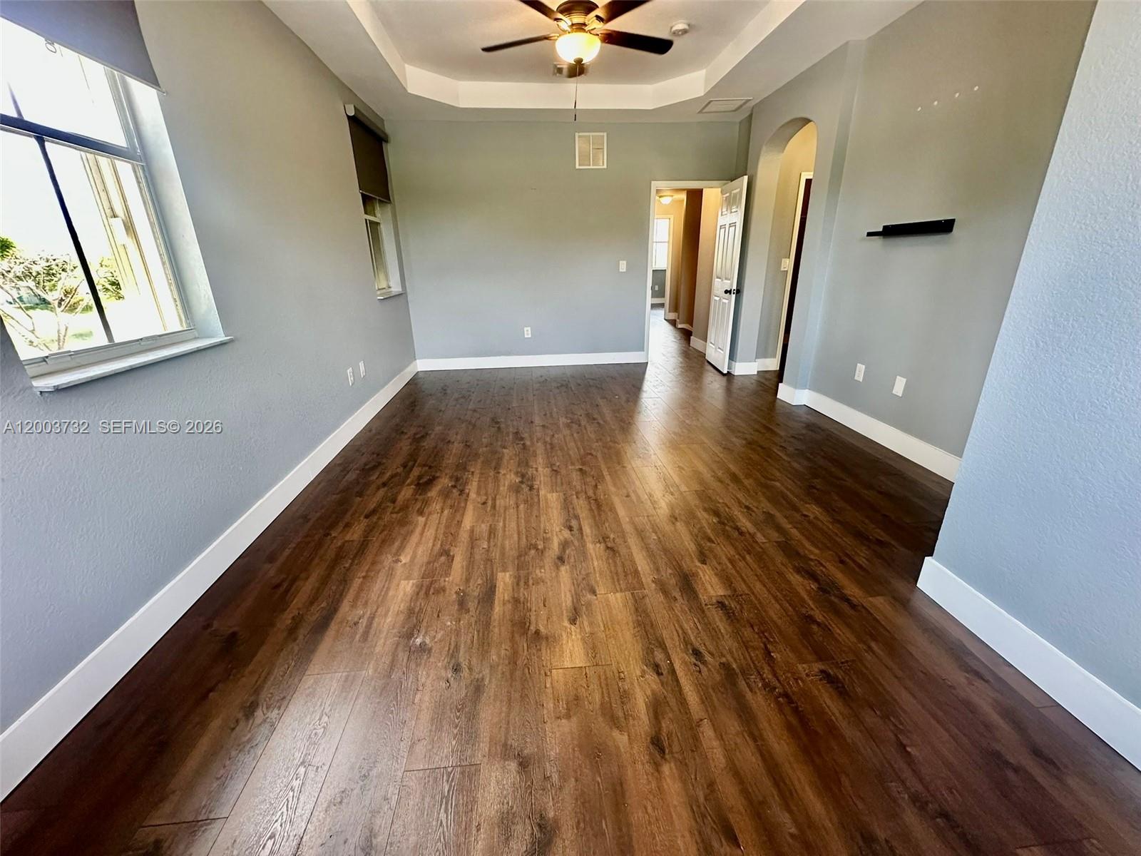 16537 Southwest 78th Terrace Miami, FL 33193 - Photo 20 of 34 wooden floor in an empty room with a window