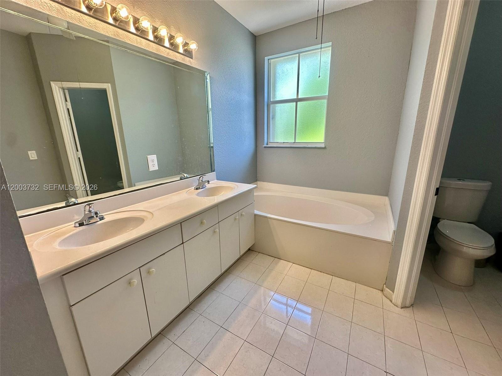 16537 Southwest 78th Terrace Miami, FL 33193 - Photo 25 of 34 a bathroom with a double vanity sink toilet and shower