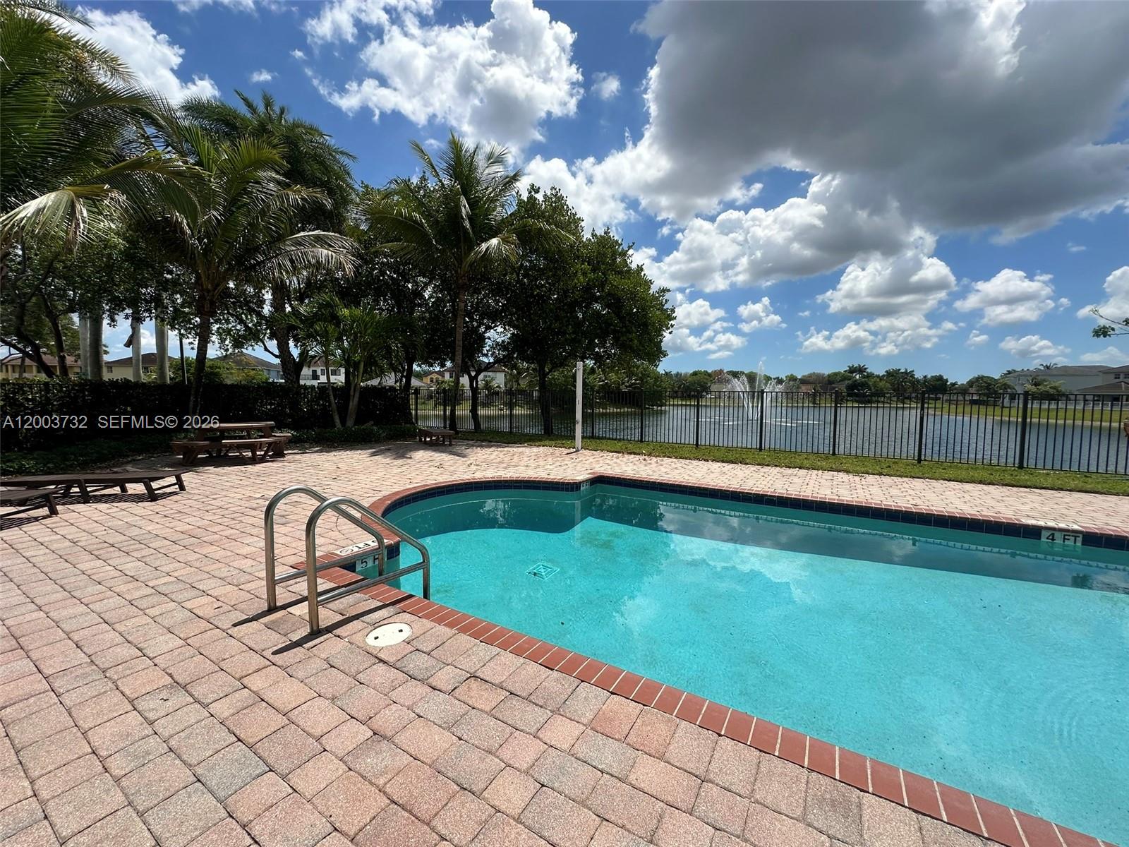 16537 Southwest 78th Terrace Miami, FL 33193 - Photo 30 of 34 a view of swimming pool with seating space and trees in the background