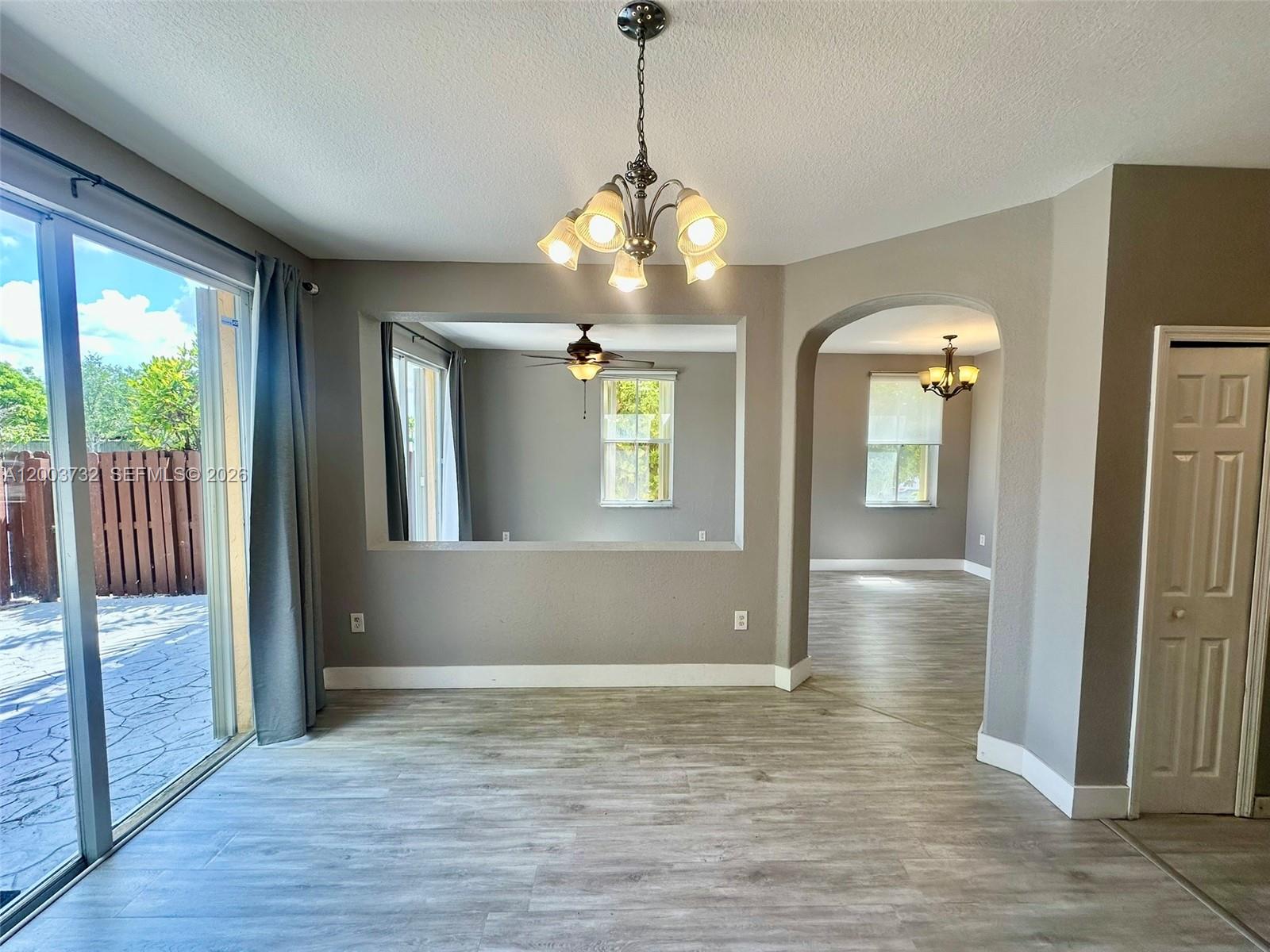16537 Southwest 78th Terrace Miami, FL 33193 - Photo 3 of 34 a view of a hallway with wooden floor and windows