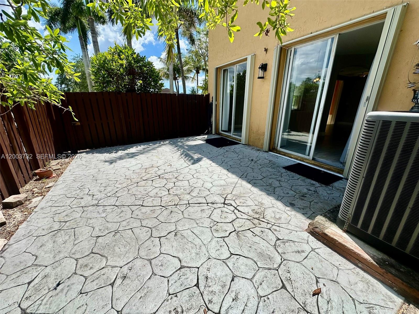 16537 Southwest 78th Terrace Miami, FL 33193 - Photo 4 of 34 a view of backyard with potted plant wooden fence