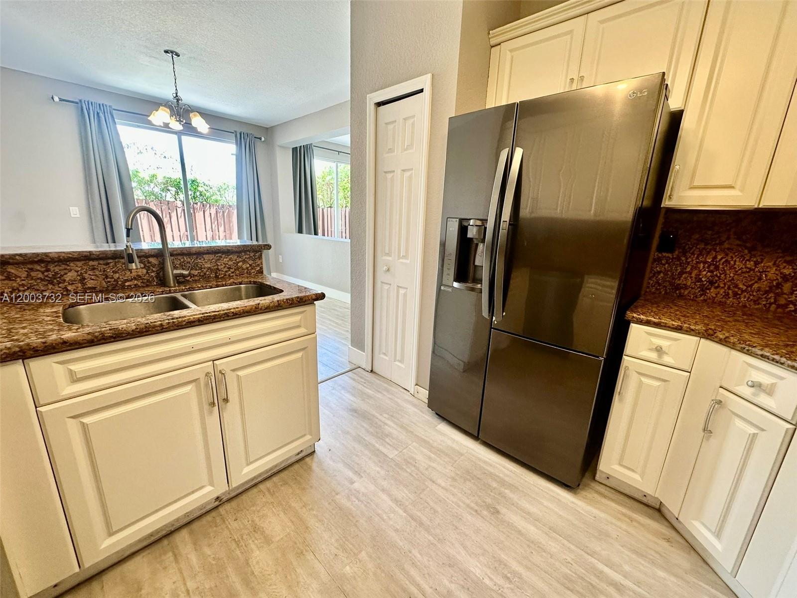 16537 Southwest 78th Terrace Miami, FL 33193 - Photo 9 of 34 a kitchen with stainless steel appliances granite countertop a refrigerator and a sink