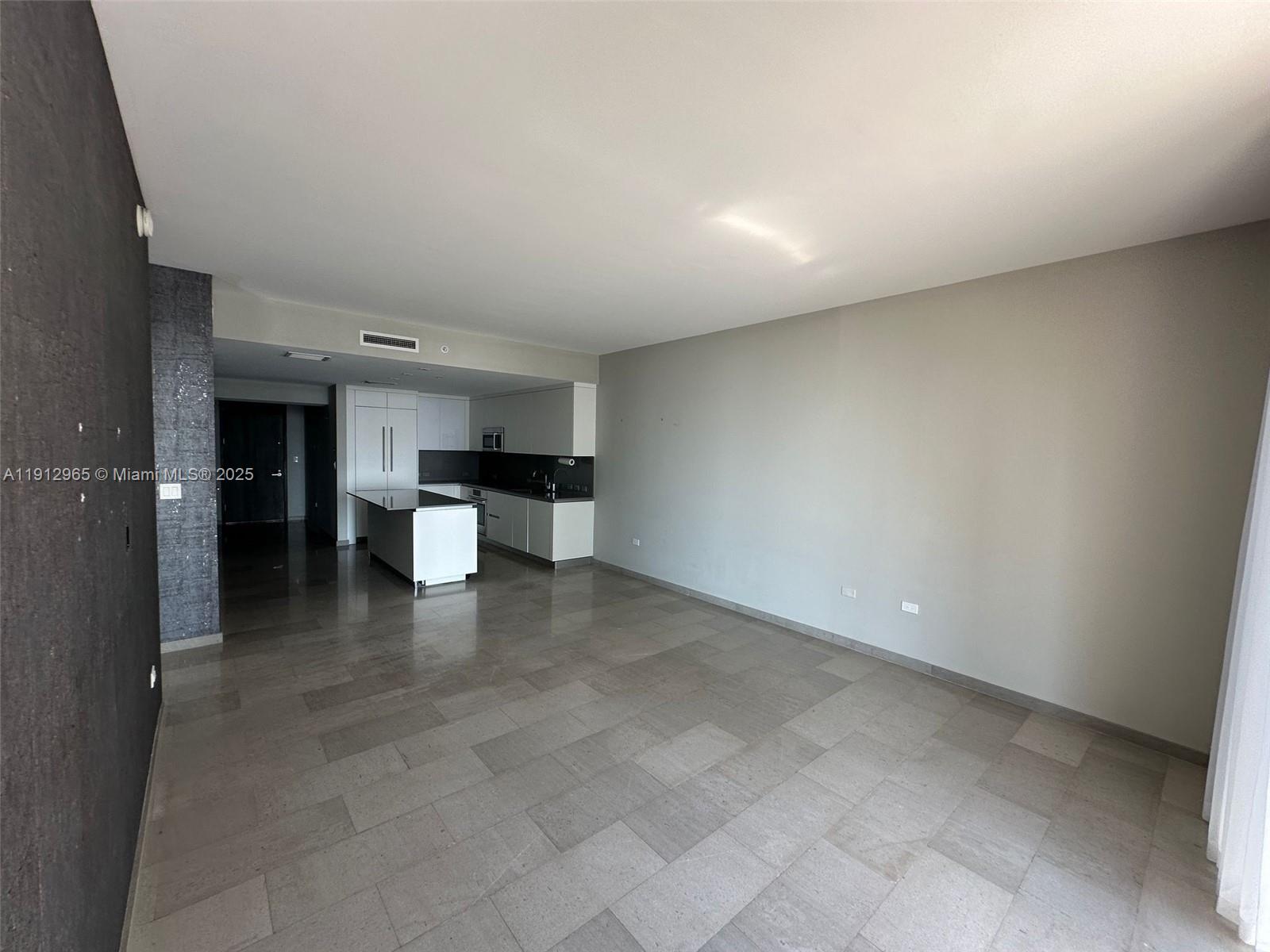 68 Southeast 6th Street, Unit 2205 Miami, FL 33131 - Photo 11 of 28 a view of a kitchen with a sink and a refrigerator